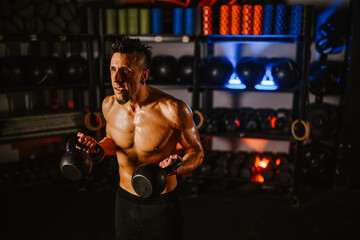 Portrait of a man training with kettlebells in a crossfit style gym