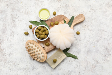 Wall Mural - Composition with green olives, oil and bath supplies on light background