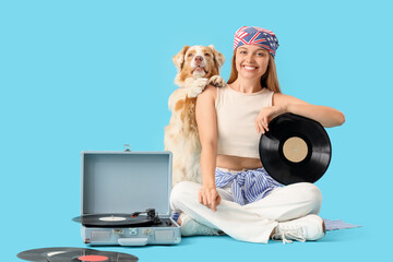 Poster - Young woman with vinyl disk for record player and Australian Shepherd dog sitting on blue background