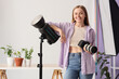 © Pixel-Shot - Female photographer with professional equipment and plants on table in photo studio