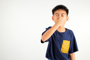 Asian young child unhappy what a smell disgust expression squeezing nose with fingers. Kid boy primary have something stinks bad smell situation, studio shot isolated on white background, Healthcare