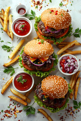 Wall Mural - Three hamburgers with lettuce and onions on top, and three french fries