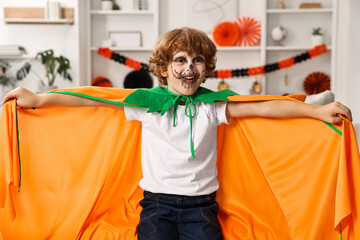 Canvas Print - Funny boy dressed like pumpkin for Halloween celebration in room