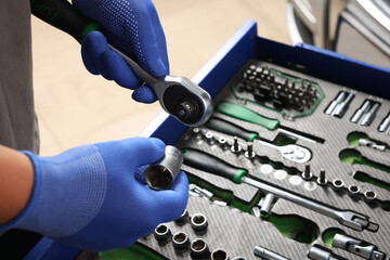 Poster - Auto mechanic with different tools at automobile repair shop, closeup