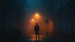 © Supriyanto - A solitary figure stands in a foggy street illuminated by streetlights at night.