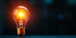 © CHONCHANOK PHOTO - A glowing light bulb illuminates a dark background, symbolizing inspiration and creativity in a modern setting.