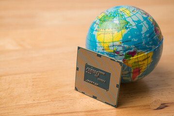 CPU (central processing unit) computer, globe on wooden table background. US vs China chip war or tech war, semiconductor industrial competition concept. US restrict and control chip export to China.