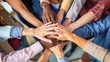 © Surachetsh - Business professionals place their hands together in a show of unity and collaboration, shared commitment to success in a corporate environment.
