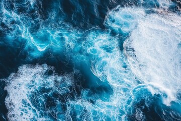 Wall Mural - ocean waves from above: a whirl of blue and white