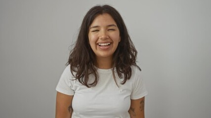 Canvas Print - Young hispanic woman standing with tongue out, wearing white t-shirt, showing funny and happy expression in isolated background, sticking tongue out for fun