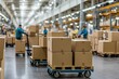 © Wan - A busy warehouse scene showcasing workers handling cardboard boxes on pallet carts in an organized storage area.