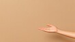 © Nuchylee - A relaxed hand gesture against a neutral, warm backdrop, perfect for conveying openness and invitation in various contexts.