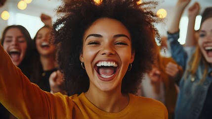 A Young Woman With Curly Hair Laughs Enthusiastically Surrounded by Friends