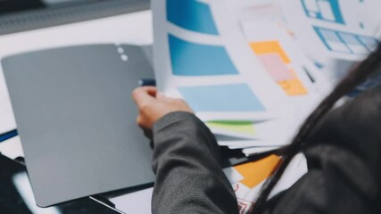 ux developers and ui designers, data researchers brainstorm on tabletop mobile app interface wireframe design with client summary color codes the modern office Creative Digital Development Agency.