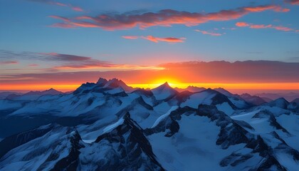 Serene sunset over snow-capped mountains with a deep blue sky and vibrant orange sun casting a tranquil glow on the landscape