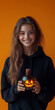 © Creative Valley - Festive Halloween with Glowing Potion Bottle and Woman on Solid Orange Backdrop
