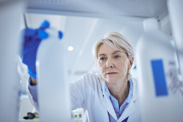 Poster - Mature scientist, product and medical research in science lab for chemistry experiment in healthcare. Female person, storage and chemical for pharmaceutical test, analysis or mpox vaccine in hospital