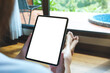 © Farknot Architect - Mockup image of a woman holding digital tablet with blank desktop screen at home