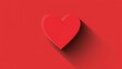 © BozStock - Red heart with a long shadow on a red background.