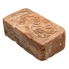 A close-up view of a carved stone block with intricate floral designs. The block is rectangular in shape and shows signs of aging. The stone has a warm brown hue and is textured, highlighting the intr