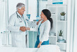 © peopleimages.com - Doctor, woman and handshake in office for welcome, greeting and friendly service in healthcare. Mature gynecologist, patient and gesture in practice for trust, consultation and assurance in clinic