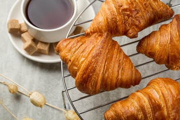 Wall Mural - Tea with croissants on a light table. Sweet breakfast