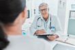 © peopleimages.com - Happy doctor, checklist and patient in consultation for healthcare, checkup results and advice. Medical professional, clipboard and mature man in hospital. appointment for help, question and report