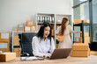 © laddawan - Starting small businesses SME owners, two check online orders Selling products working with boxs freelance work
