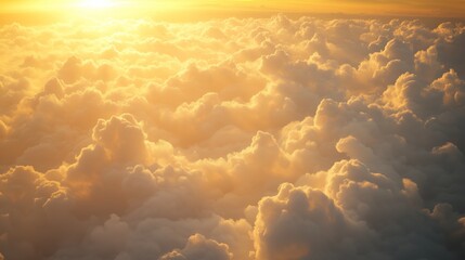 Wall Mural - golden sunrise illuminating fluffy clouds above a serene landscape, captured during early morning ho