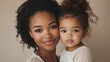 © MK studio - A loving moment captured as a mother embraces her African-American daughter, both radiating joy and warmth. Their close bond is beautifully captured in this intimate portrait.
