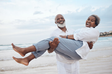 Happy, portrait and senior black couple on beach for travel, vacation or getaway with bonding. Love, excited and elderly man carrying wife by ocean or sea for retirement holiday together in Morocco.