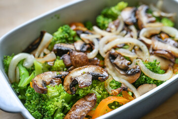 Mushrooms, broccoli, onion and bell peppers in a casserole, healthy cooking and eating with vegetables, vegetarian and vegan, selected focus,