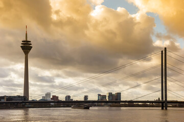 Colorful sky over the Rheinturm tower and bridge in Dusseldorf, Germany