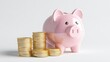 © Tackey - A charming pink piggy bank beside stacks of shiny coins, symbolizing savings, finance, and prosperity for personal budgeting.