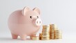 © Tackey - A close-up of a pink piggy bank beside a stack of shiny gold coins, symbolizing savings and financial growth.