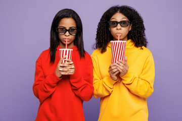 Wall Mural - Two young little kid teen girls women they wear red yellow hoodie casual clothes hold in hand cup of soda pop drink cola fizzy water isolated on plain pastel light purple background Lifestyle concept