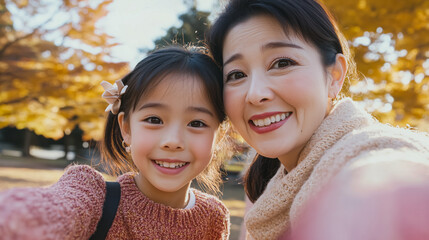 Sticker - Japanese mother and daughter taking a selfie at the park, scenic background,