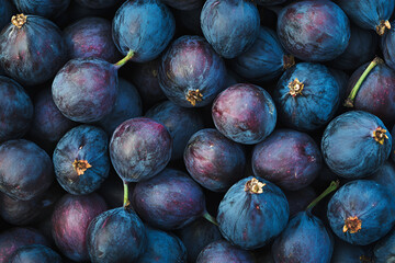 Top view of the pile of deep purple fresh ripe figs with selective focus