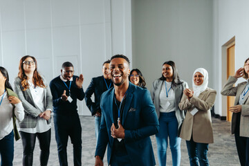 Wall Mural - confident male leader energizing group during a conference