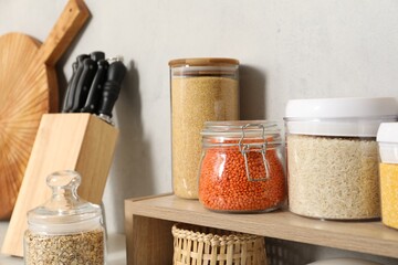 Wall Mural - Different types of cereals and legumes in containers on light table