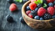 © Teeranan - Close-up of a variety of fresh, colorful berries in a rustic wooden bowl, emphasizing their antioxidant properties and focus on promoting brain health and overall well-being