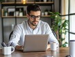 © Rudsaphon - Young Professional Working Remotely in Cozy Office Environment