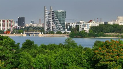 Wall Mural - Bucharest from above. Aerial 4K video with Ciurel Bridge and Dambovita River, filmed from Morii Lake. Landmarks and main roads of Bucharest during a summer day.