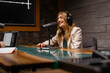 © Big Shot Theory - A woman is equipped in a studio to record a podcast professionally with modern audio technology