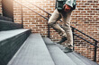 © TamJam/peopleimages.com - Businessman, legs and walking in city, steps and commute in urban town to workplace. Male person, shoes and professional on journey to opportunity, outdoor and employee travel on stairs to metro