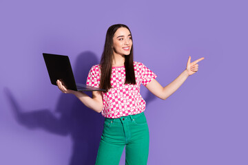 Canvas Print - Photo of attractive young woman hold netbook point look empty space dressed stylish pink clothes isolated on violet color background