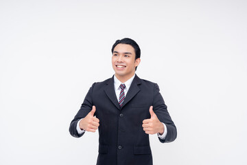 Candid portrait of an optimistic young asian business executive in a fashionable suit and tie. Arms crossed, make two thumbs up. Isolated on a white background.