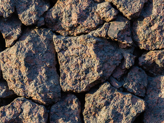 Rough granite stones. The texture of the stone wall. Great for background and design.