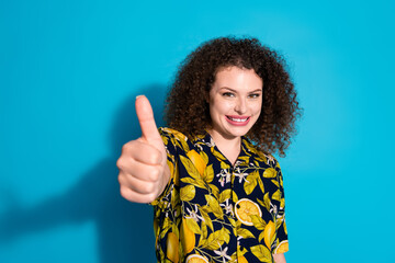 Photo of adorable lovely girl wear print shirt showing you thumb up empty space isolated blue color background