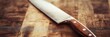© StockUp - A sharp kitchen knife with a wooden handle is placed on a wooden cutting board, ready for use.